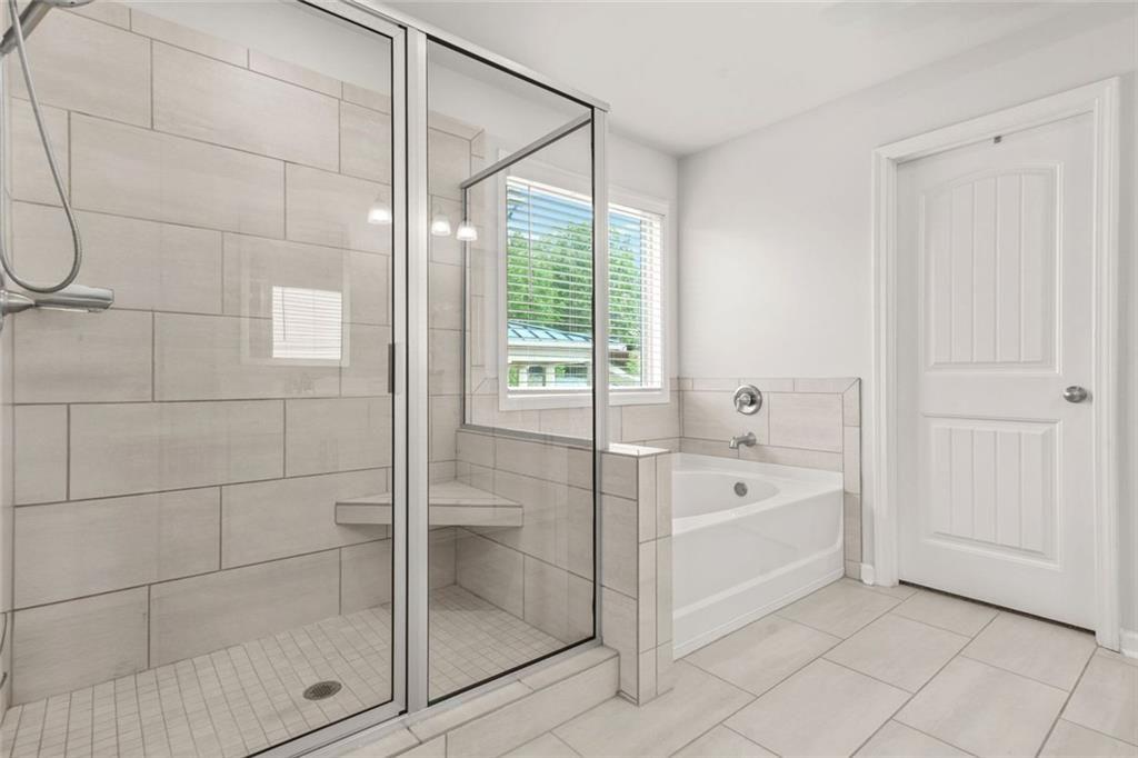 1606 Chancery Lane Lithia Springs, GA 30122 - Photo 48 of 66 a spacious bathroom with a bathtub and a shower