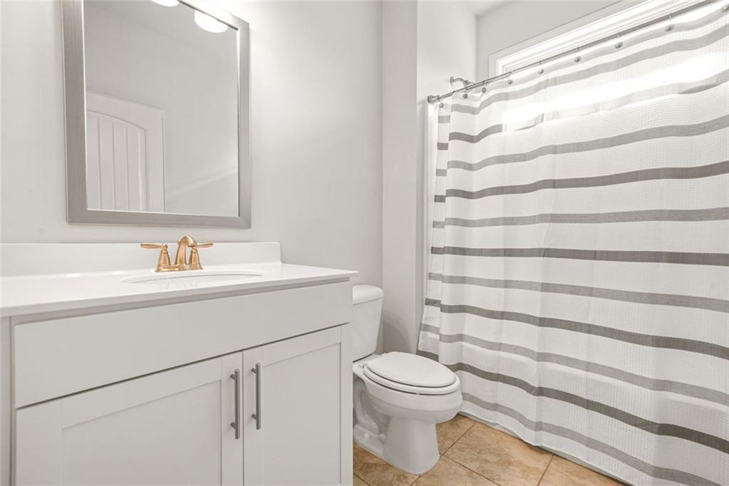 1606 Chancery Lane Lithia Springs, GA 30122 - Photo 49 of 66 a bathroom with a sink toilet and shower