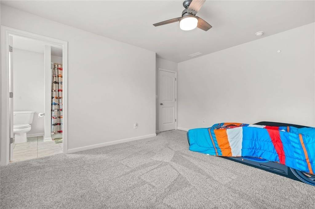 1606 Chancery Lane Lithia Springs, GA 30122 - Photo 50 of 66 a living room with a rug