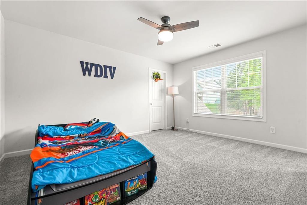 1606 Chancery Lane Lithia Springs, GA 30122 - Photo 52 of 66 a bedroom with a bed and a window