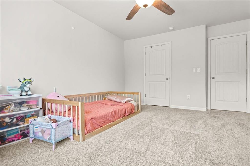 1606 Chancery Lane Lithia Springs, GA 30122 - Photo 56 of 66 a bedroom with furniture and a bed