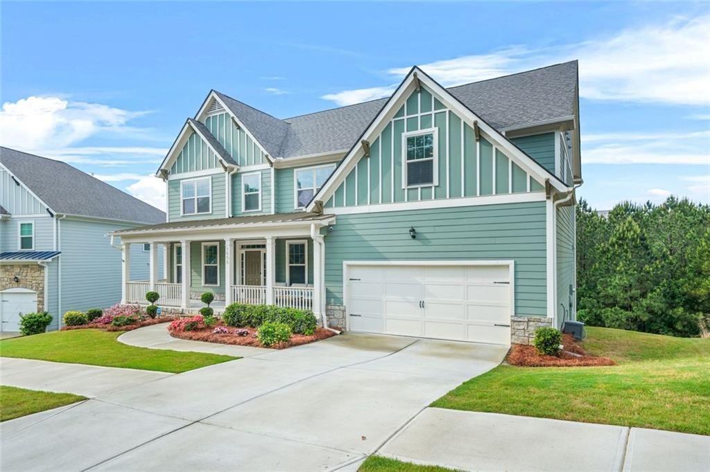 1606 Chancery Lane Lithia Springs, GA 30122 - Photo 62 of 66 a front view of a house with a yard and garage