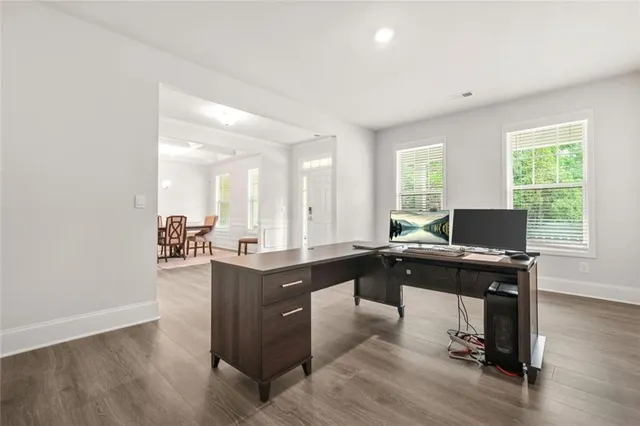 a view of a workspace with furniture and a window