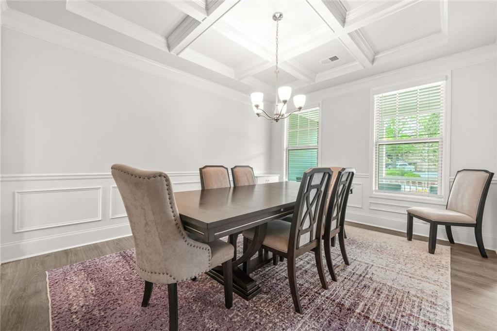 1606 Chancery Lane Lithia Springs, GA 30122 - Photo 8 of 66 a view of a dining room with furniture a chandelier and wooden floor