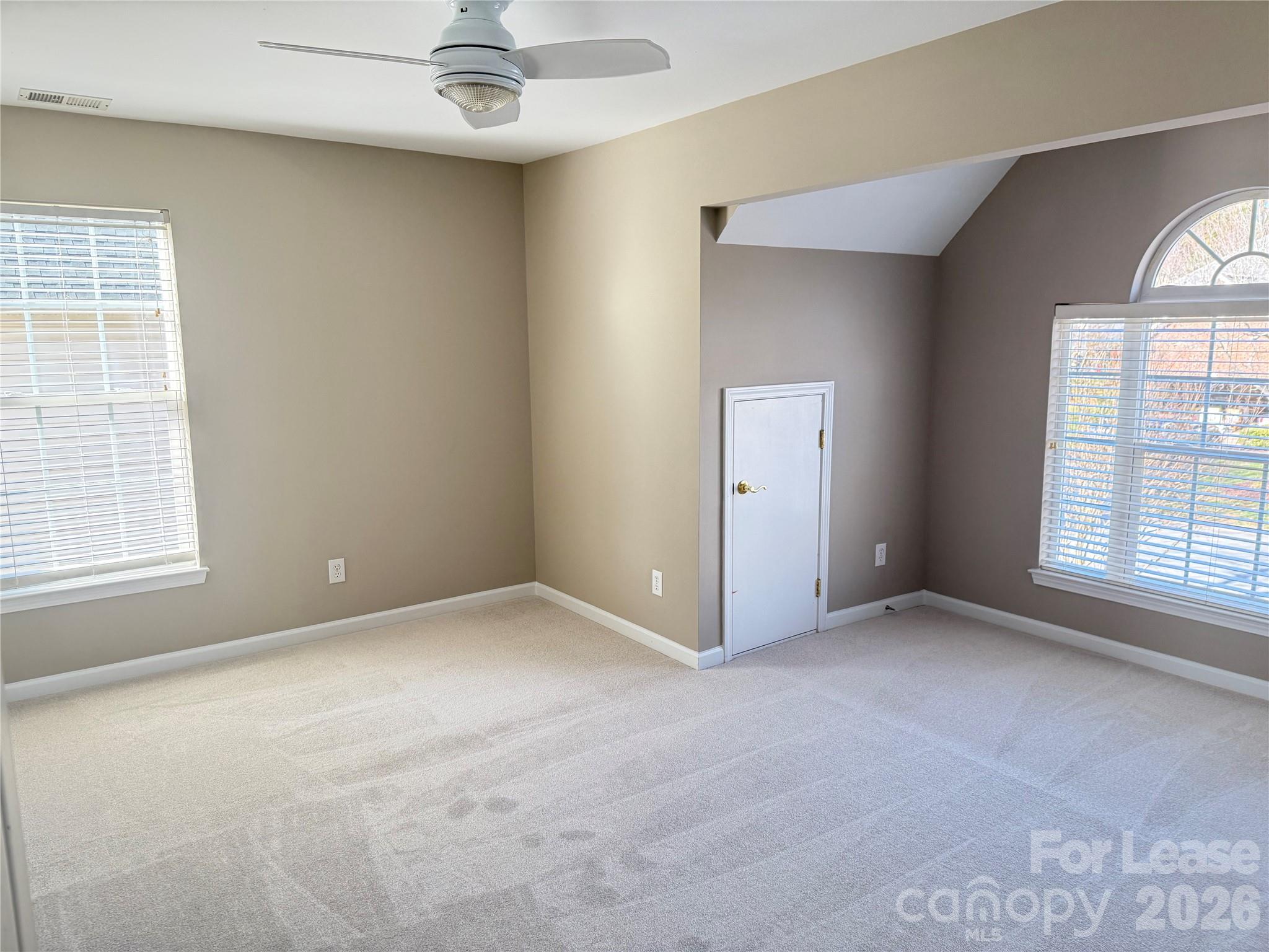 13518 Northbourne Road Huntersville, NC 28078 - Photo 8 of 15 an empty room with windows and chandelier fan