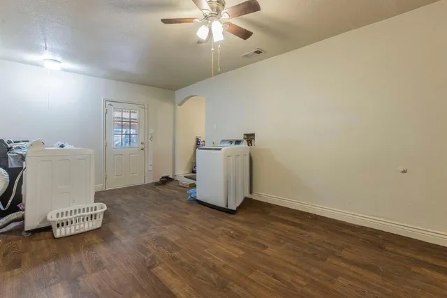 a view of a room with wooden floor and white walls