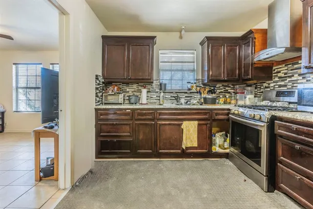 a kitchen with a stove and a sink