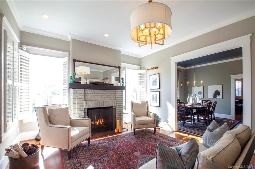 2220 Vail Avenue Charlotte, NC 28207 - Photo 2 of 23 a living room with furniture chandelier and a fireplace