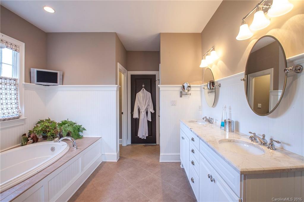 2220 Vail Avenue Charlotte, NC 28207 - Photo 12 of 23 a bathroom with a tub double vanity sink and a mirror