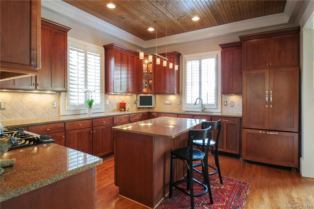 2220 Vail Avenue Charlotte, NC 28207 - Photo 4 of 23 a kitchen with stainless steel appliances granite countertop wooden floors and a stove top oven