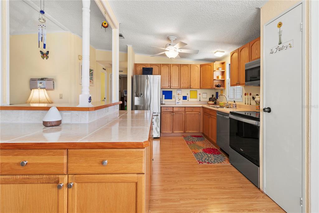 148 Nightingale Circle Ellenton, FL 34222 - Photo 11 of 47 a kitchen with stainless steel appliances a sink stove and cabinets