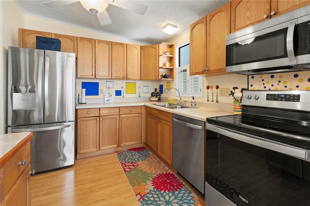 148 Nightingale Circle Ellenton, FL 34222 - Photo 14 of 47 a kitchen with a sink stove and refrigerator