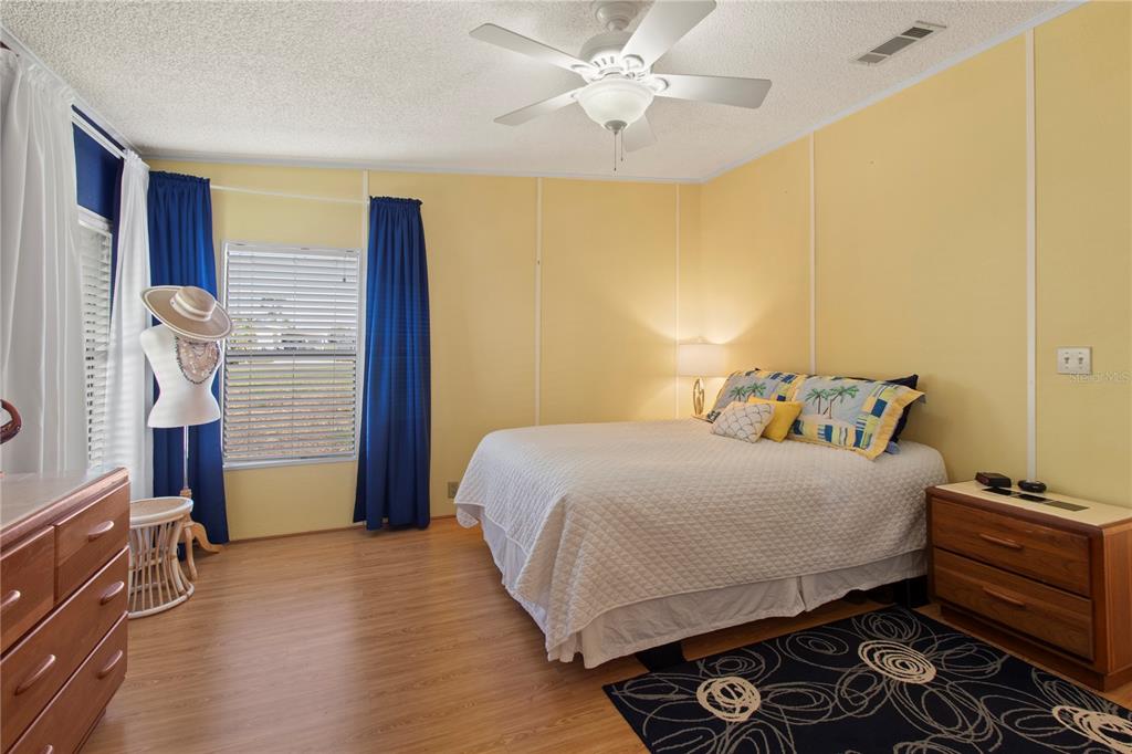 148 Nightingale Circle Ellenton, FL 34222 - Photo 18 of 47 a bedroom with a bed and wooden floor