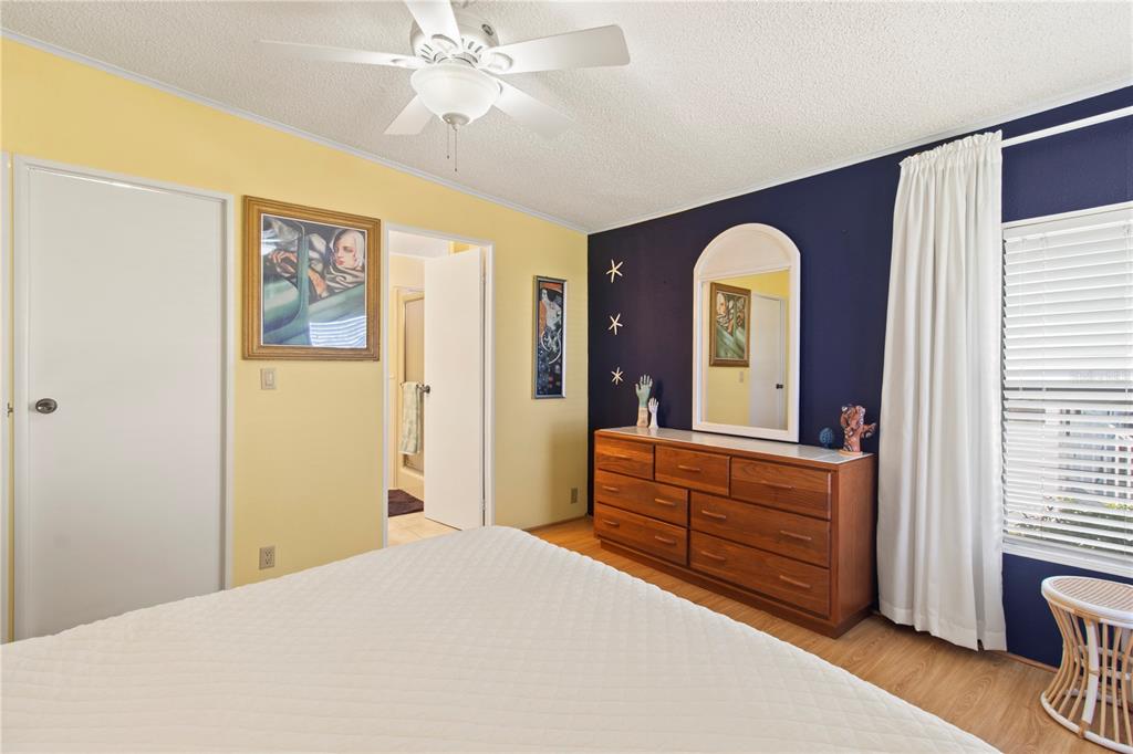 148 Nightingale Circle Ellenton, FL 34222 - Photo 19 of 47 a bedroom with a bed and a chandelier