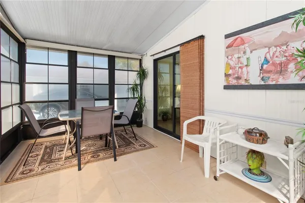 a view of a dining room with furniture a rug and a window