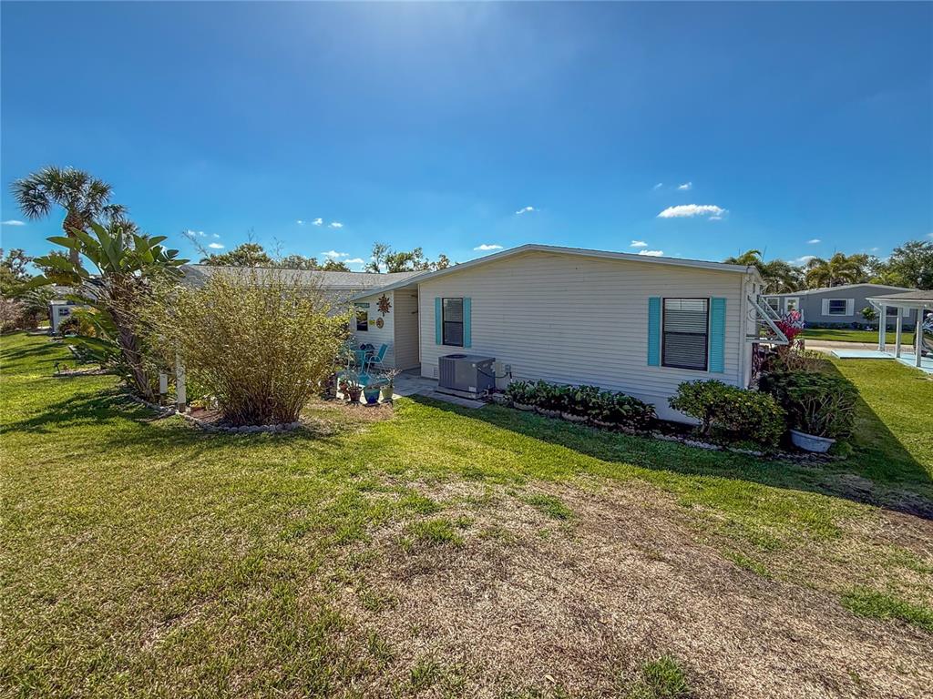 148 Nightingale Circle Ellenton, FL 34222 - Photo 33 of 47 a view of a house with a backyard and a patio