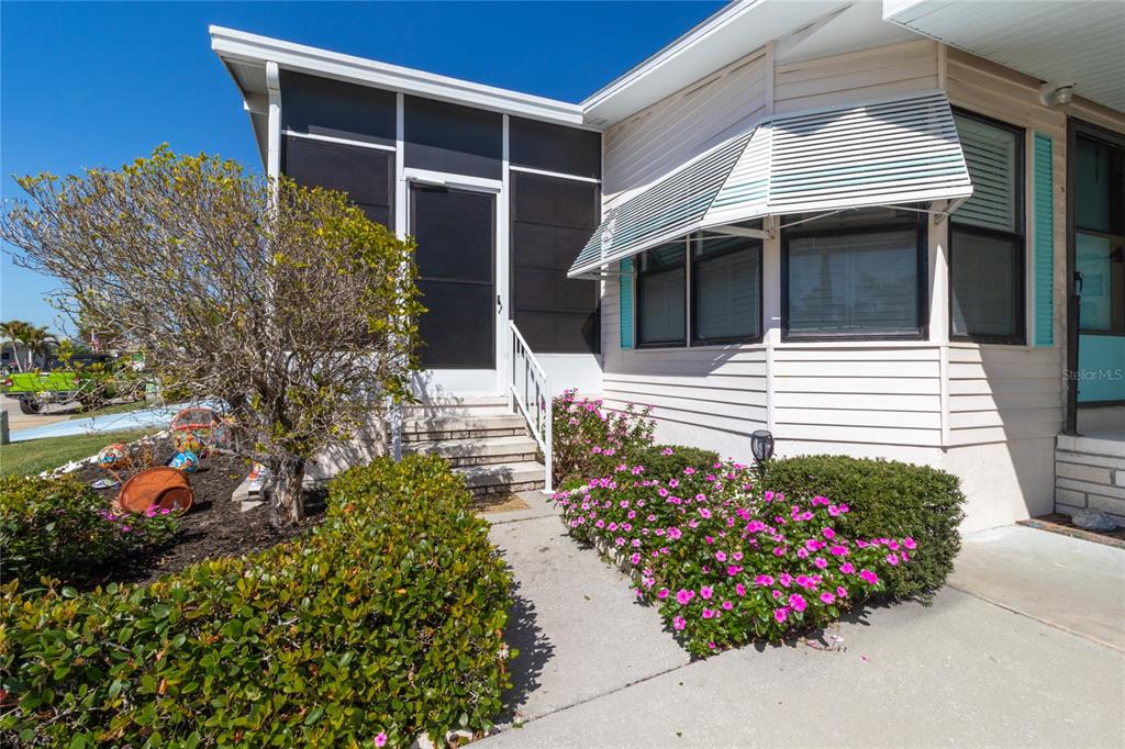 148 Nightingale Circle Ellenton, FL 34222 - Photo 4 of 47 a view of a house with a flower garden