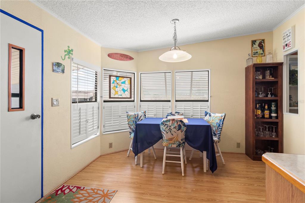 148 Nightingale Circle Ellenton, FL 34222 - Photo 9 of 47 a dining room with furniture a chandelier and wooden floor