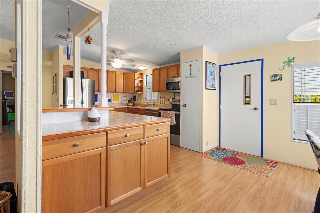 148 Nightingale Circle Ellenton, FL 34222 - Photo 10 of 47 a kitchen with white cabinets and refrigerator