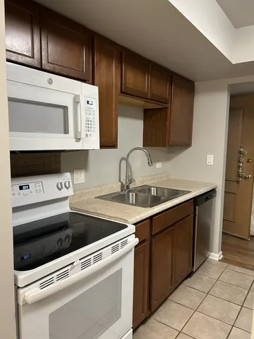 a kitchen with stainless steel appliances a sink stove and cabinets