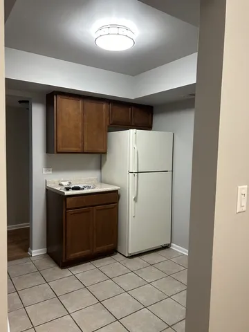 a kitchen with stainless steel appliances granite countertop a refrigerator and a stove