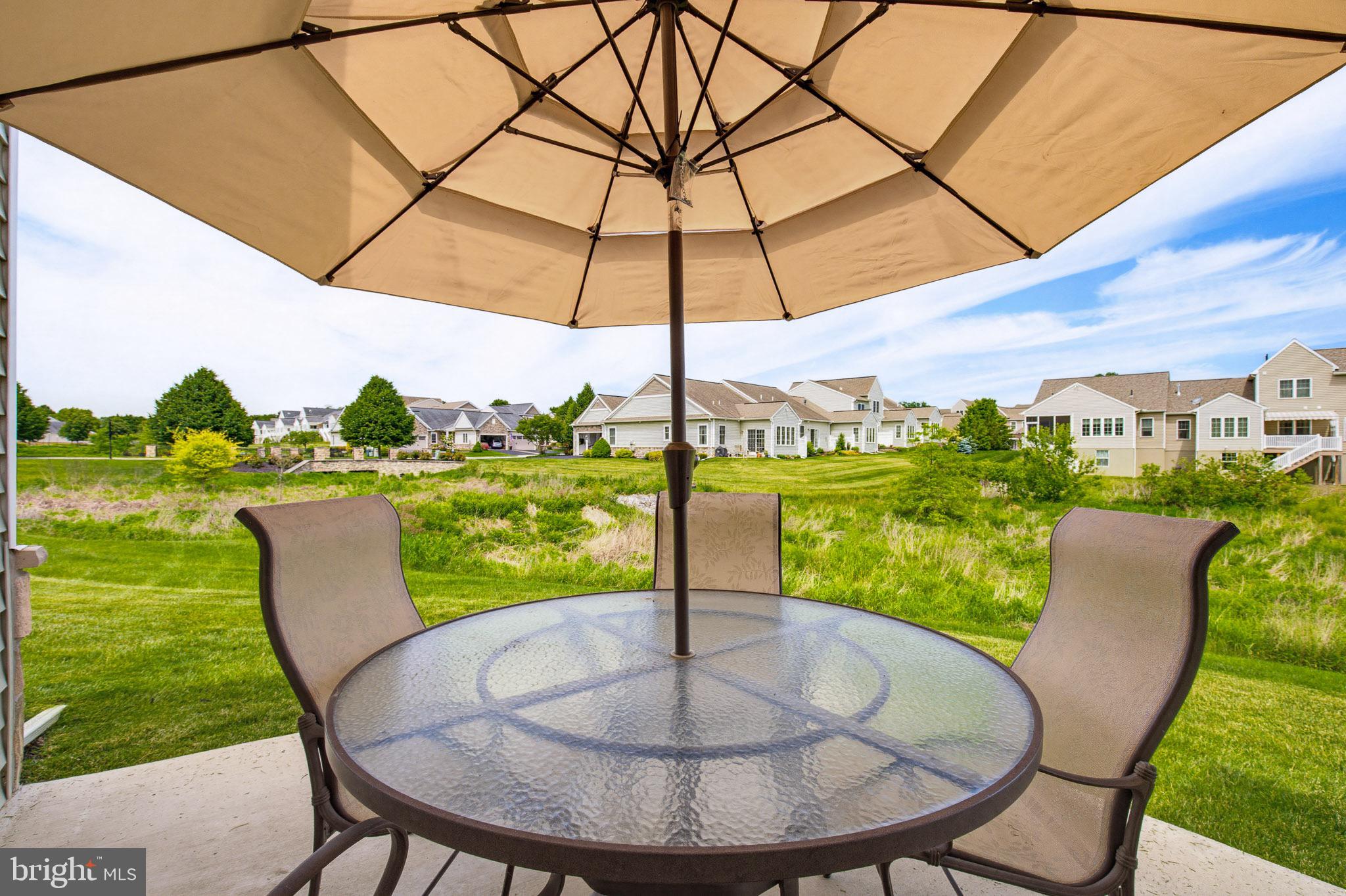361 Meadow Rose Drive Lititz, PA 17543 - Photo 29 of 39 a view of a patio with a table chairs and a backyard