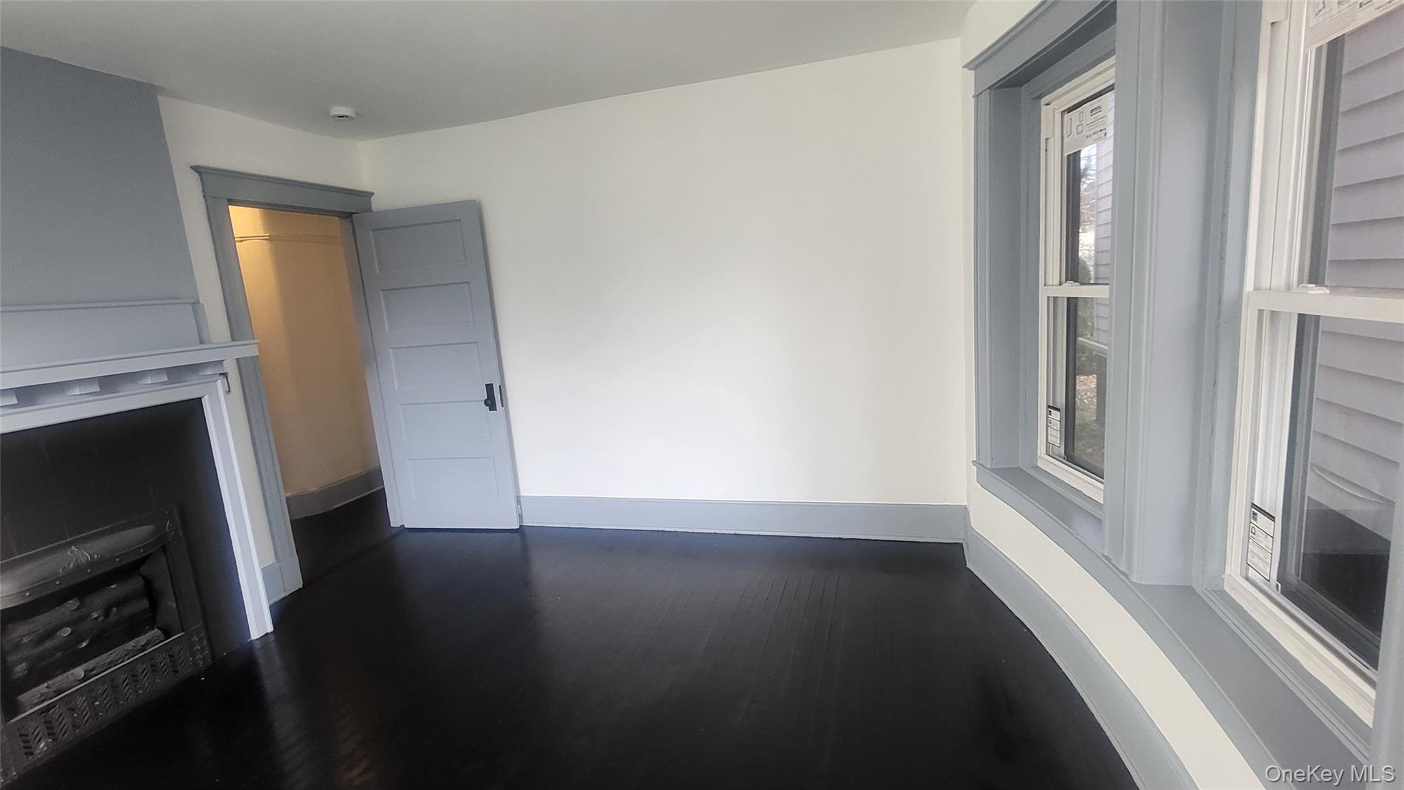 76 South Hamilton Street, Unit 2 Poughkeepsie, NY 12601 - Photo 12 of 19 a view of an empty room with wooden floor and a window