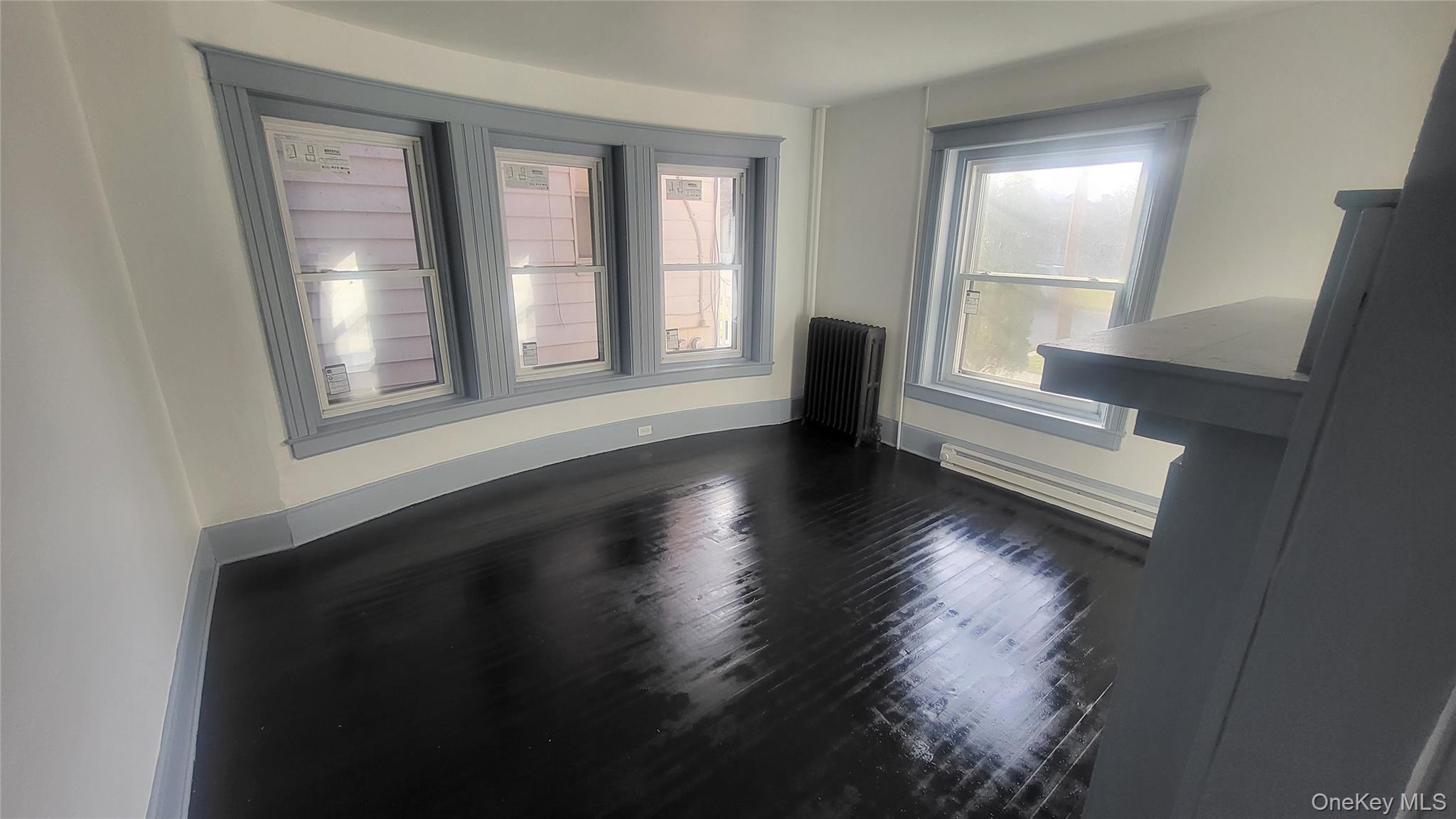 76 South Hamilton Street, Unit 2 Poughkeepsie, NY 12601 - Photo 13 of 19 a view of an empty room with wooden floor and a window
