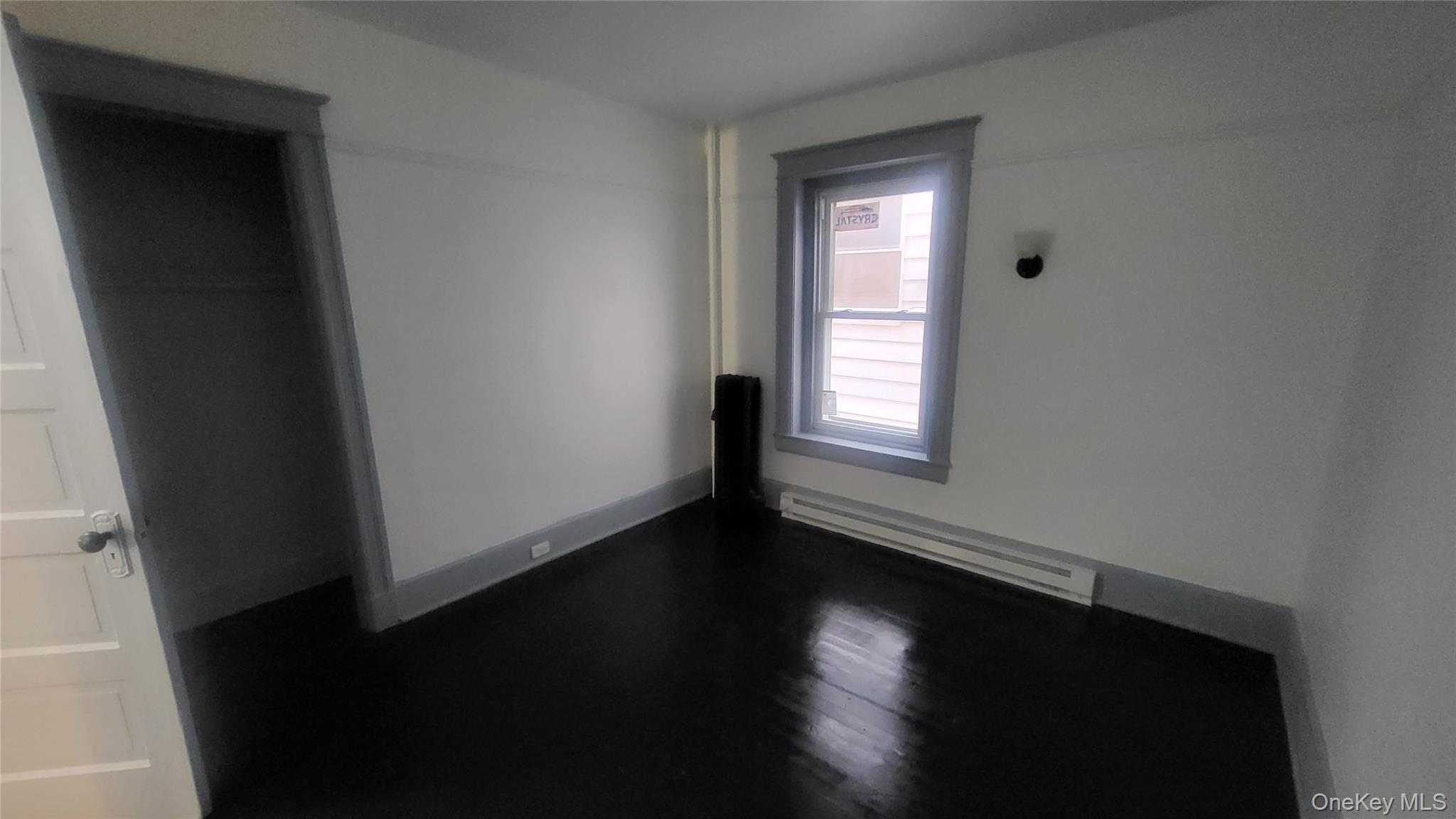 76 South Hamilton Street, Unit 2 Poughkeepsie, NY 12601 - Photo 15 of 19 an empty room with wooden floor and windows