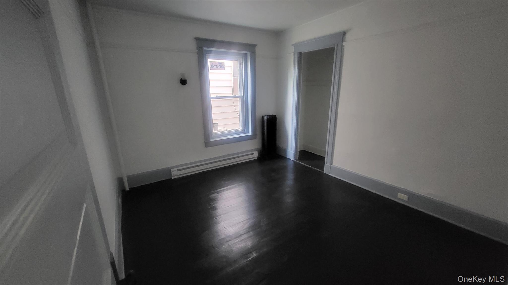 76 South Hamilton Street, Unit 2 Poughkeepsie, NY 12601 - Photo 17 of 19 an empty room with wooden floor and windows