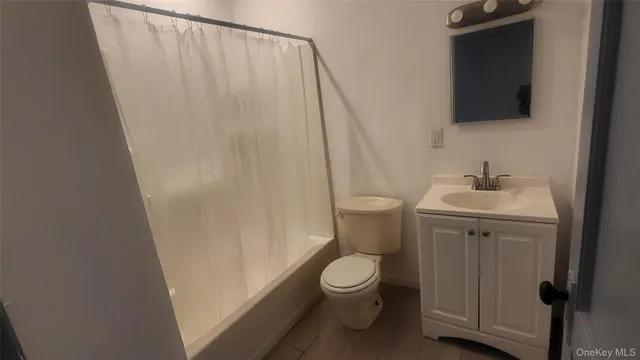 a white toilet sitting next to a white sink