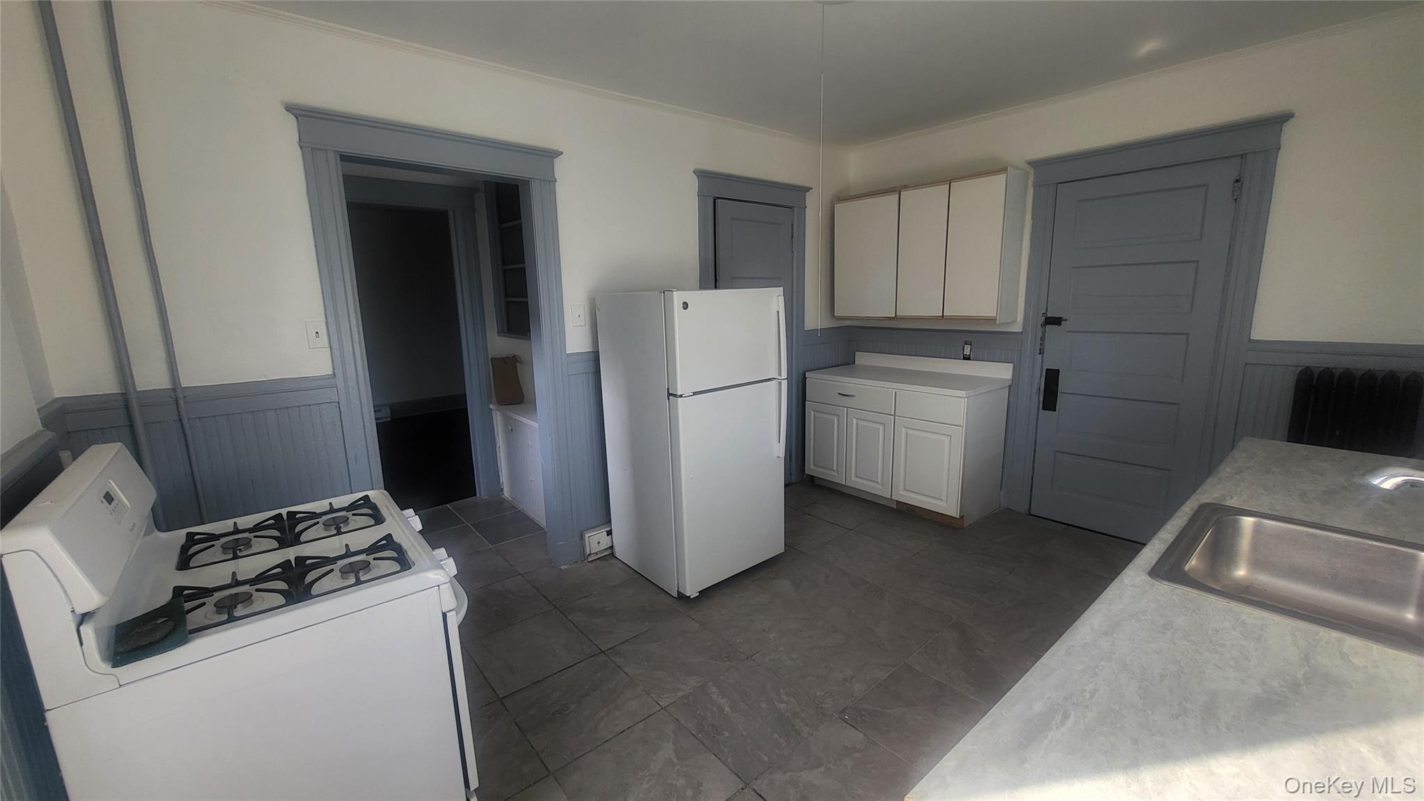 76 South Hamilton Street, Unit 2 Poughkeepsie, NY 12601 - Photo 4 of 19 a kitchen with a refrigerator sink stove and cabinets