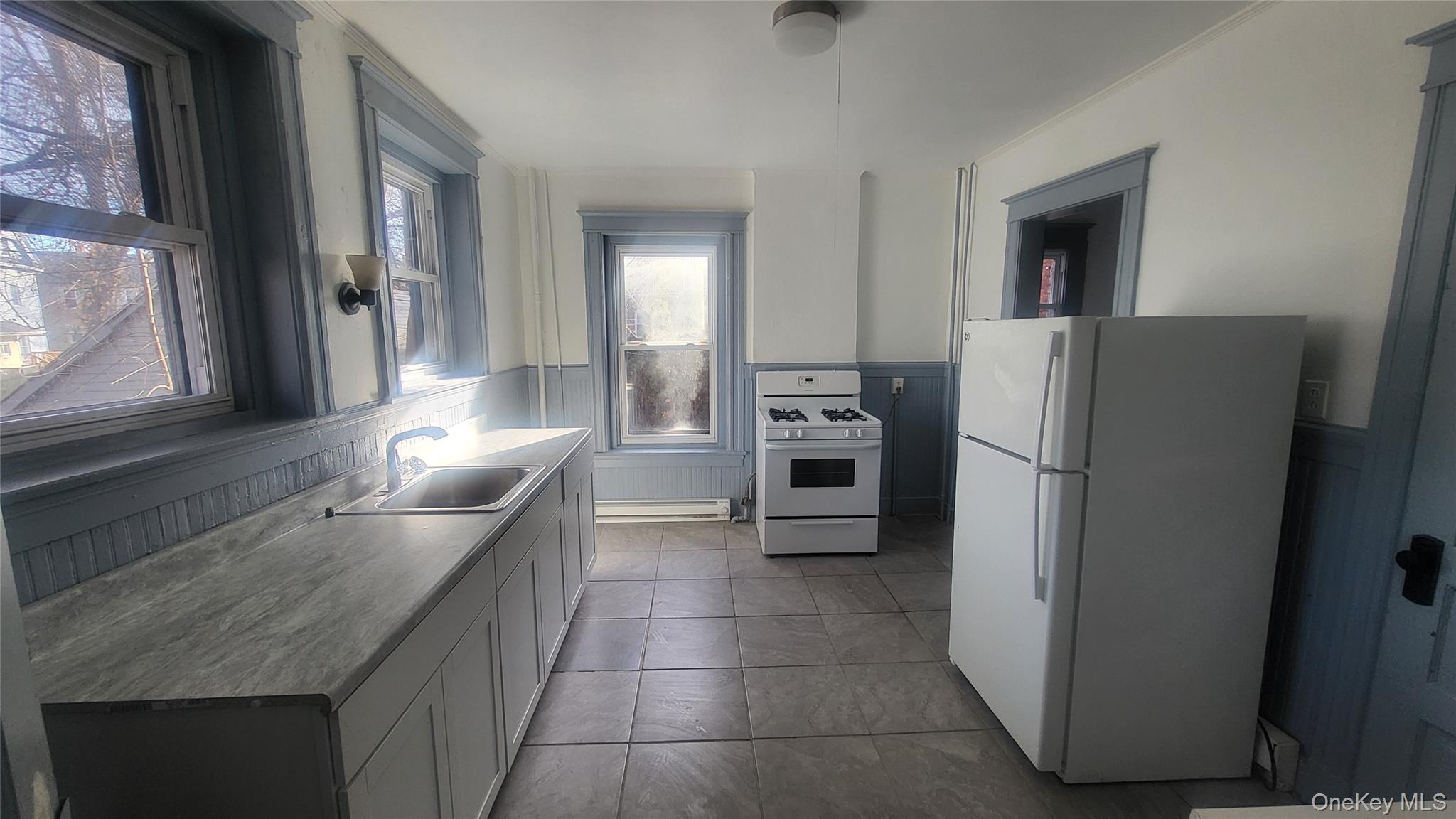 76 South Hamilton Street, Unit 2 Poughkeepsie, NY 12601 - Photo 5 of 19 a kitchen with granite countertop a refrigerator and a stove