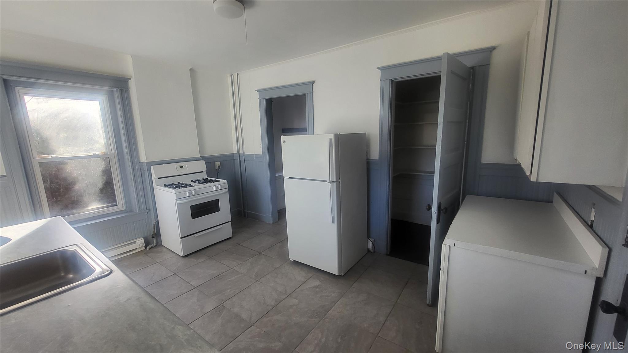 76 South Hamilton Street, Unit 2 Poughkeepsie, NY 12601 - Photo 6 of 19 a kitchen with a refrigerator sink and stove