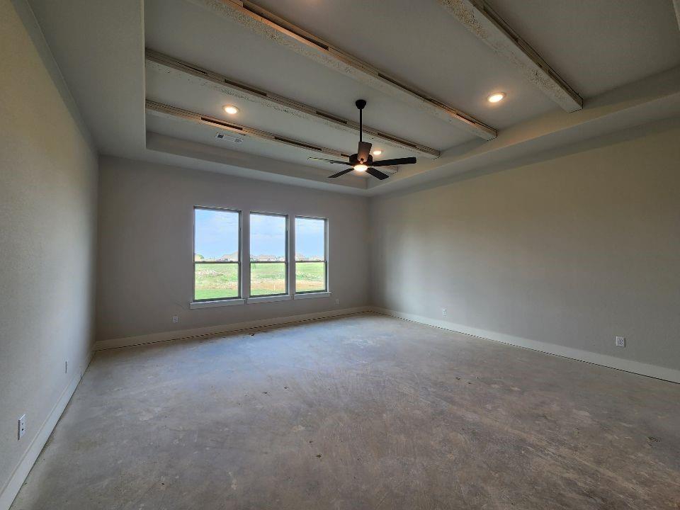 2305 Gypsum Street Krum, TX 76249 - Photo 15 of 22 Expansive room featuring a tray ceiling with wood-finish beams and recessed lighting