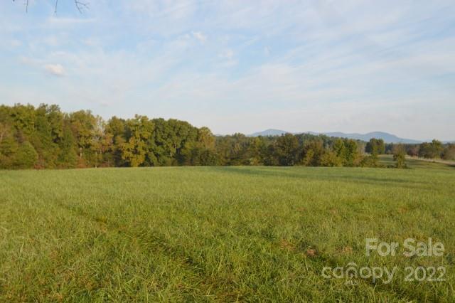 a view of a field with an ocean
