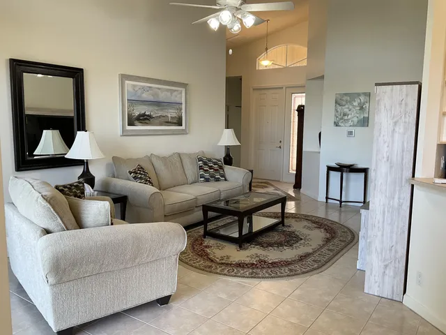 a living room with furniture and a chandelier