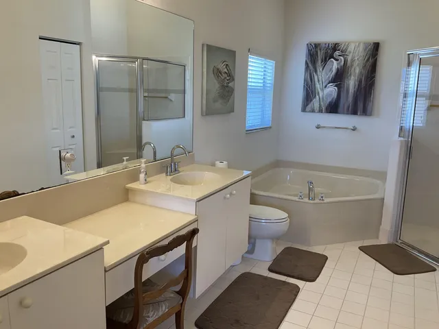 a bathroom with a granite countertop sink a toilet and bathtub