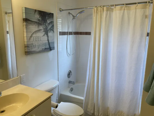 a bathroom with a sink and a shower curtain