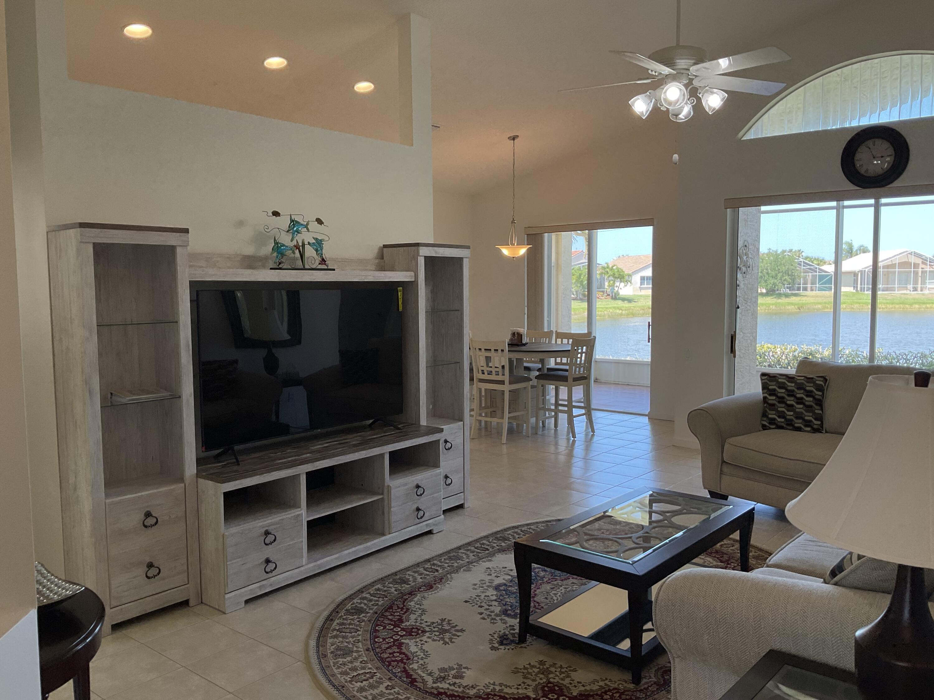 364 Sunview Way Port St. Lucie, FL 34986 - Photo 2 of 34 a living room with furniture and a flat screen tv