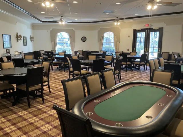 a room with lots of chairs and a chandelier