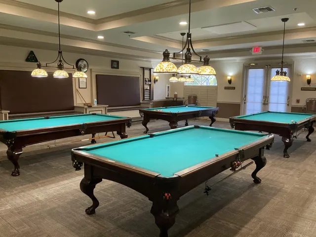 a room with pool tables and windows