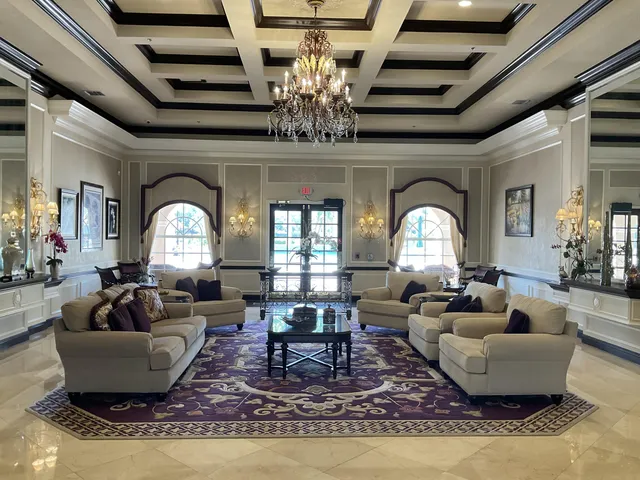 a living room with fireplace furniture and a chandelier