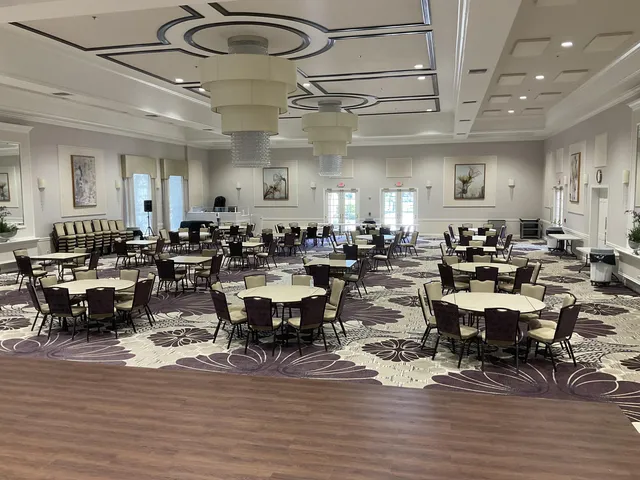 a large room with lots of white furniture