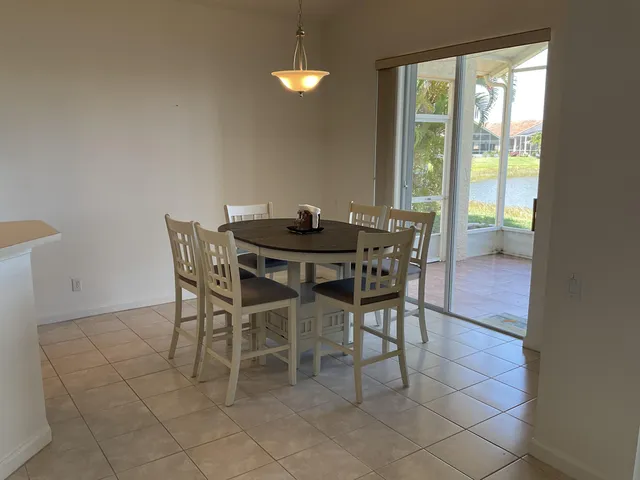 a view of a dining room with furniture and a chandelier
