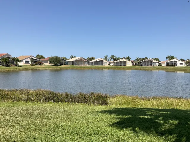 a view of a lake with houses in the back