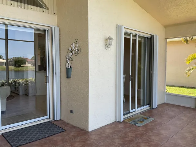 a view of a hallway with bathroom and glass door