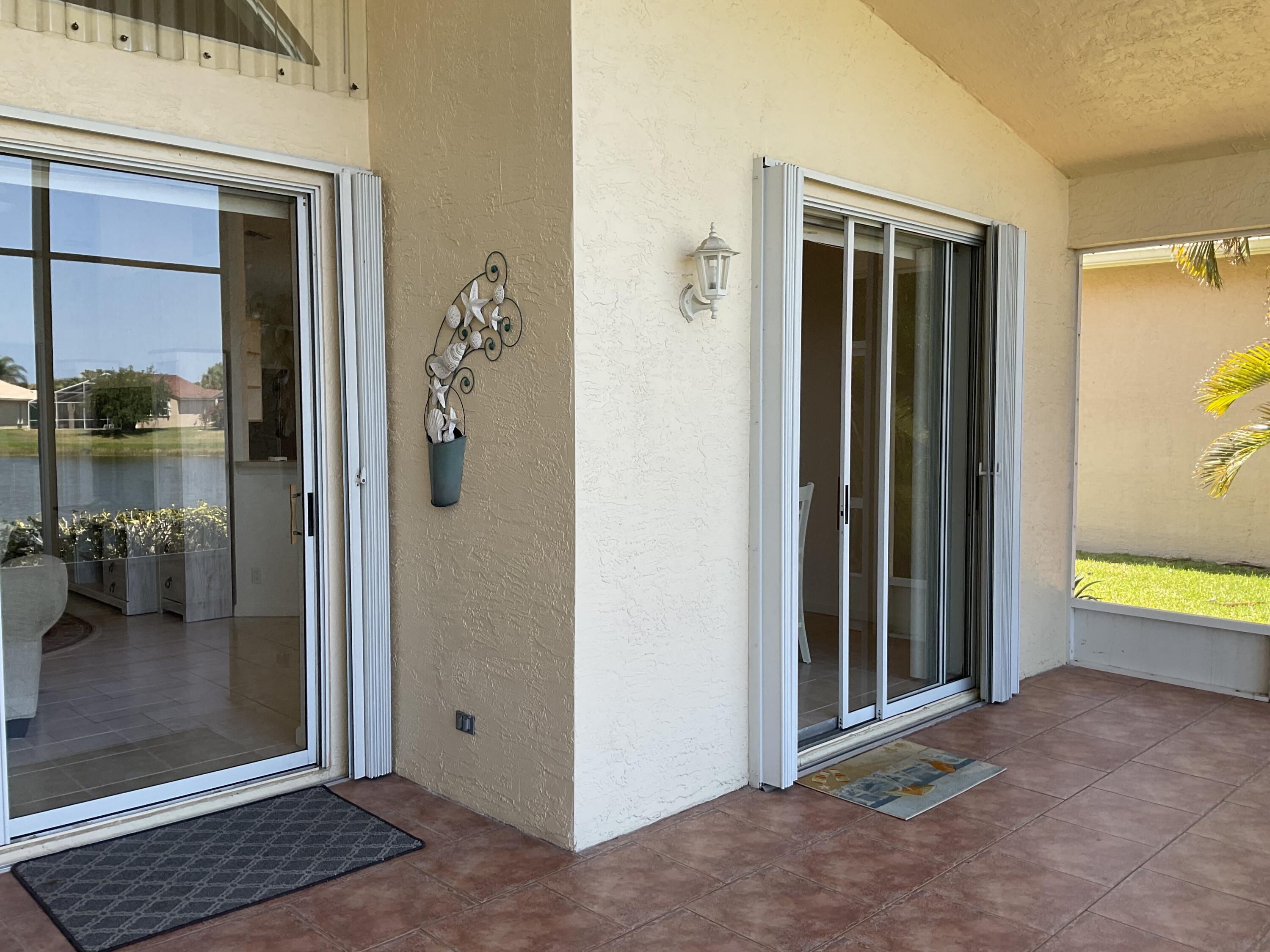 364 Sunview Way Port St. Lucie, FL 34986 - Photo 6 of 34 a view of a hallway with bathroom and glass door