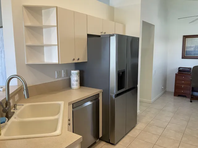 a kitchen with stainless steel appliances a refrigerator and a sink