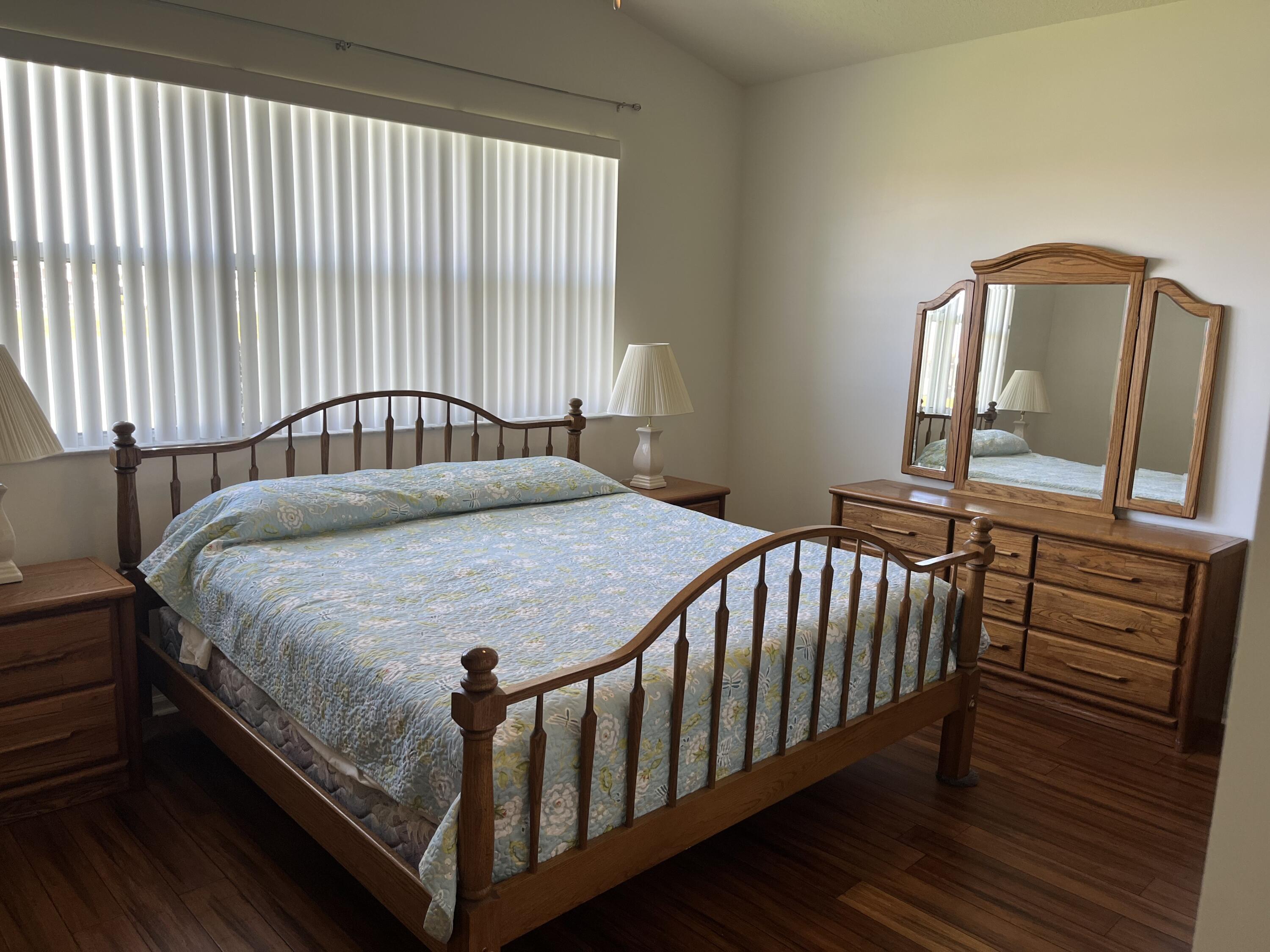 364 Sunview Way Port St. Lucie, FL 34986 - Photo 10 of 34 a bed sitting in a bedroom next to a window